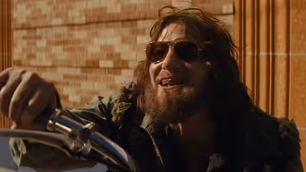 Johnny (Tom Hardy) smiling while riding a motorcycle