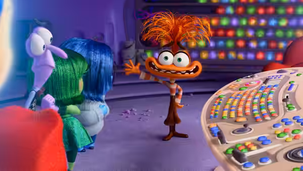 Anxiety gesturing toward other emotions beside a large colorful control panel