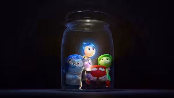 Joy, Sadness, Anger and Disgust clustered inside a glowing glass jar
