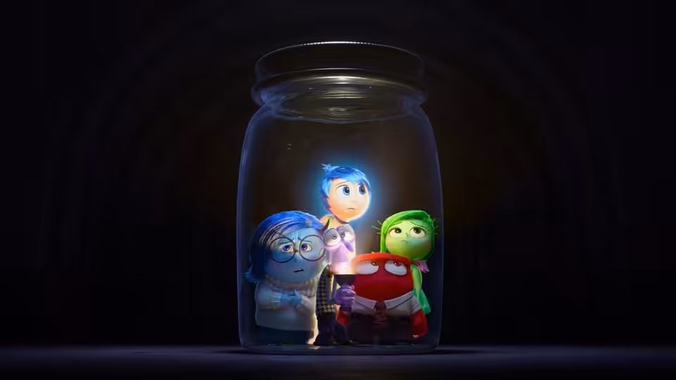 Joy, Sadness, Anger and Disgust clustered inside a glowing glass jar