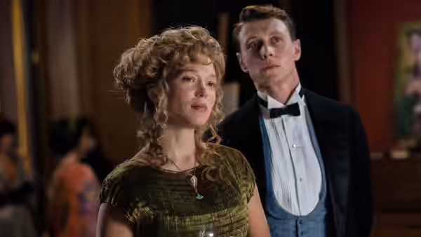 Gabrielle (Léa Seydoux) and Louis (George MacKay) standing together in formal evening wear