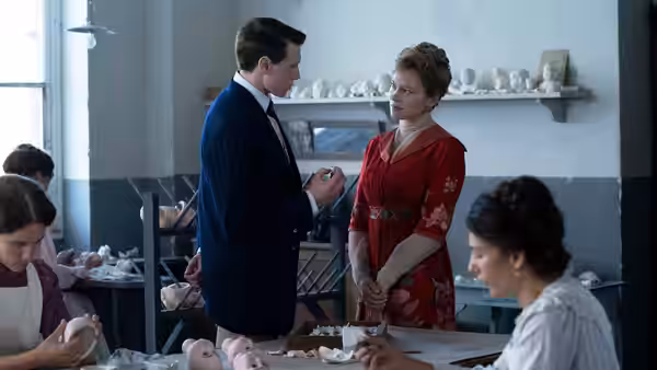 Louis (George MacKay) facing Gabrielle (Léa Seydoux) inside a doll workshop
