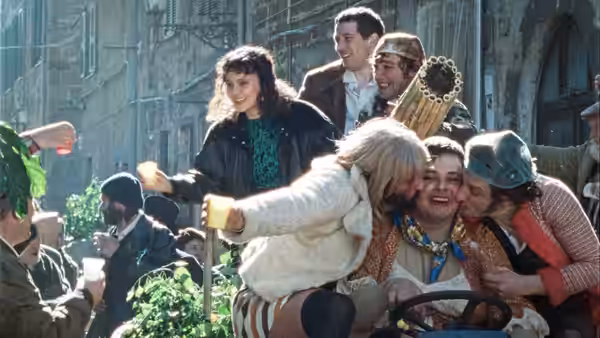 Group of people laughing and celebrating together on an open vehicle