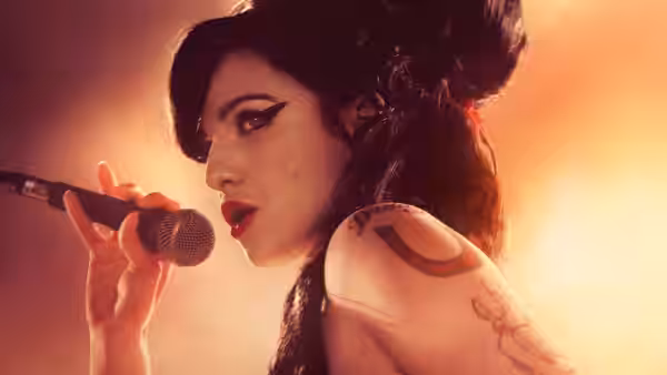 Amy (Marisa Abela) singing into a microphone in dramatic profile