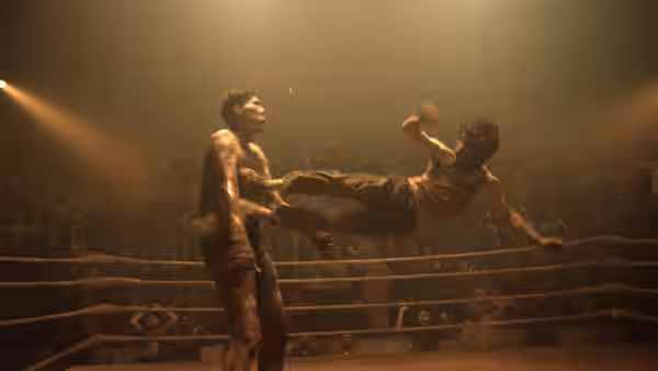one man kicks another in the chest inside a boxing ring