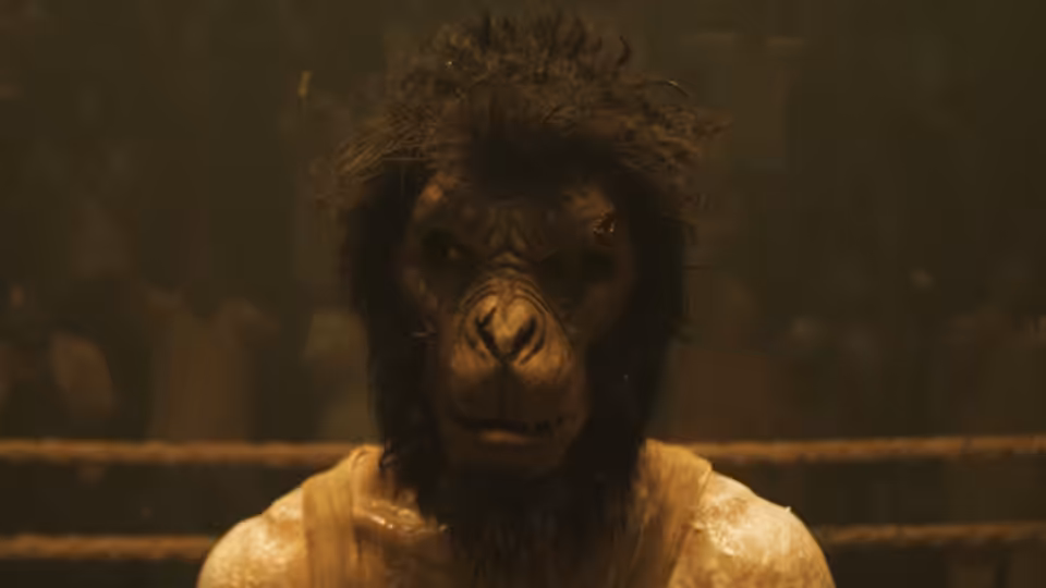 a fighter in a gorilla mask stands in a boxing ring