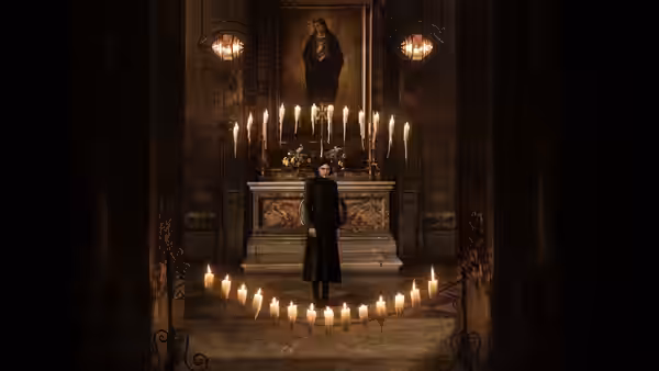 a woman in black stands among rows of candles in an ornate chapel