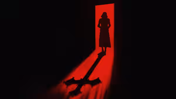 a silhouetted woman stands in a doorway casting a cross-shaped shadow in red light