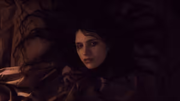 a young woman with dark hair lies on rumpled sheets looking upward