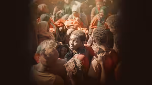 crowded people gathered inside a vehicle looking around
