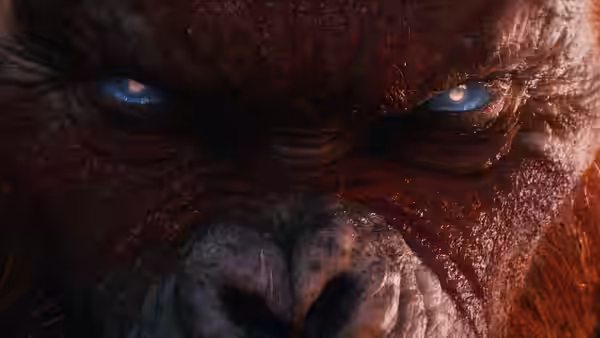 close up of a red furred ape with intense blue eyes