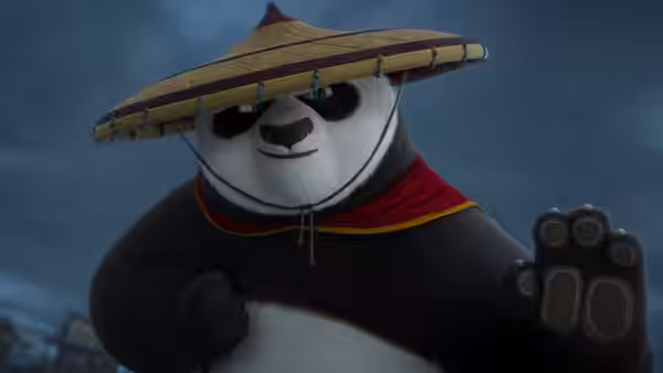 Po (Jack Black) gestures with an open paw wearing a conical hat