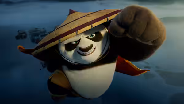 Po (Jack Black) leaps forward wearing a straw hat with fist extended
