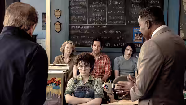 Phoebe Spengler (Mckenna Grace) sits with crossed arms during a meeting with adults