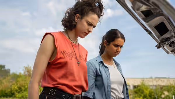 Jamie and Marian standing beside an open vehicle trunk outdoors