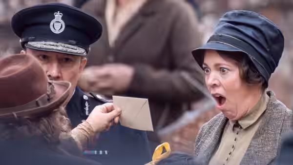 Edith Swan (Olivia Colman) exclaiming in shock as a policeman shows her a letter