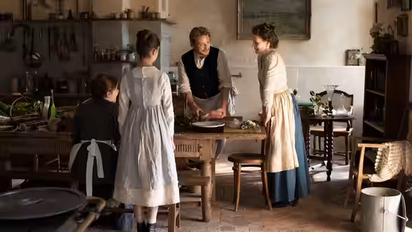 Dodin Bouffant (Benoît Magimel) showing a dish to Eugénie (Juliette Binoche) in the kitchen