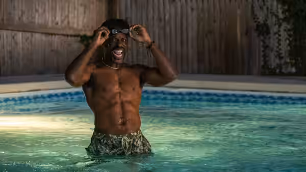 Clifford Ellison (Sterling K. Brown) adjusting his goggles in a swimming pool
