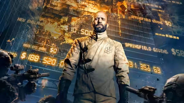 Adam Clay (Jason Statham) standing before financial data screens with armed guards