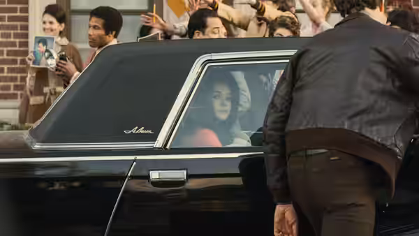 Priscilla (Cailee Spaeny) looking out from the back seat of a limousine