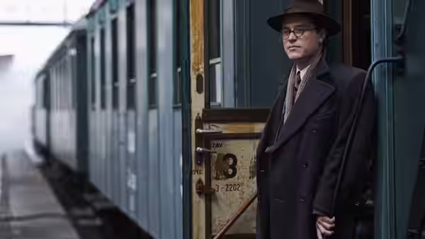 Young Nicholas Winton (Johnny Flynn) beside the door of a train carriage