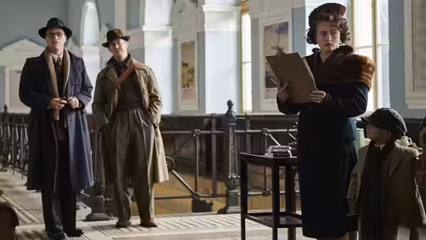 Doreen Warriner (Romola Garai) checking a list on a train platform