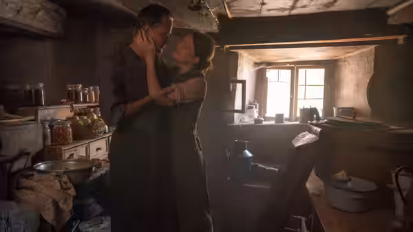 Franz Jägerstätter (August Diehl) and Fani Jägerstätter (Valerie Pachner) embracing in a rustic kitchen