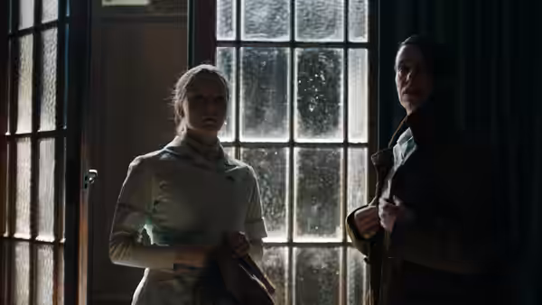 Maud (Morfydd Clark) stands beside Amanda (Jennifer Ehle) in a doorway