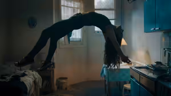 Maud (Morfydd Clark) arches above the floor in her small kitchen