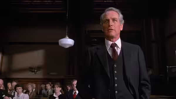 Frank Galvin (Paul Newman) standing in a courtroom looking upward