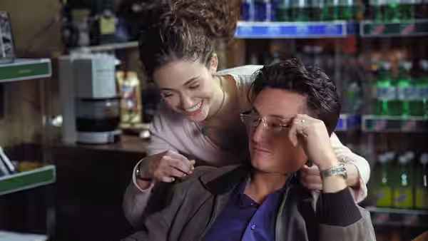 Dave Boyle (Tim Robbins) with a smiling woman in a convenience store