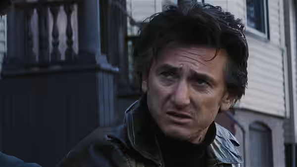 Jimmy Markum (Sean Penn) looking concerned in front of a building