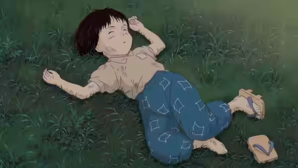 Seita (Tsutomu Tatsumi) lying on the grass with eyes closed