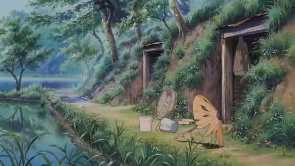 wooden houses on a grassy hillside with household items scattered outside