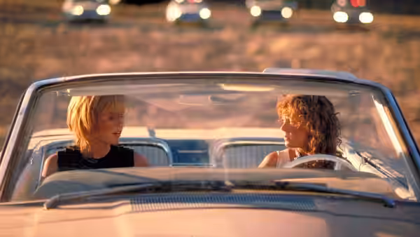 Thelma (Geena Davis) and Louise (Susan Sarandon) talking inside their convertible