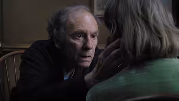Georges (Jean-Louis Trintignant) looking closely at Anne (Emmanuelle Riva) seated nearby