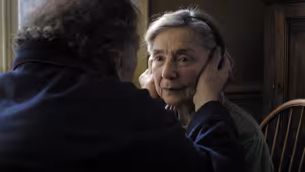 Georges (Jean-Louis Trintignant) holding Anne's (Emmanuelle Riva) face with both hands