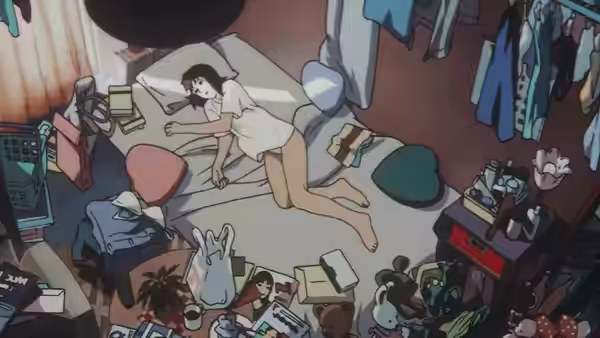Woman in a white shirt lies on the floor of a cluttered room