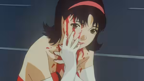 Woman with blood on her face and hand touches her cheek