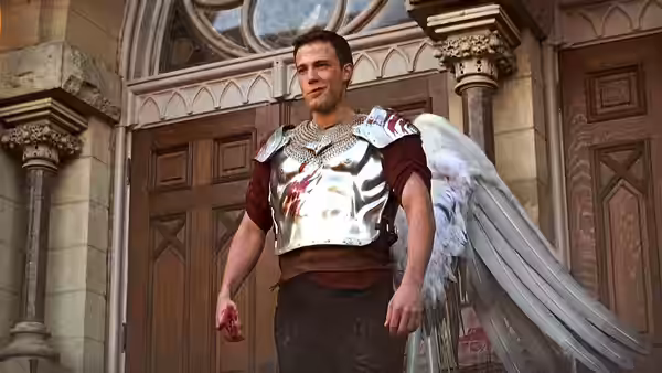 Bartleby (Ben Affleck) with large wings and armor stands before wooden doors