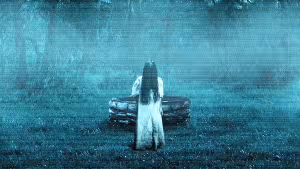 Samara (Daveigh Chase) sitting on a stone well in misty woods