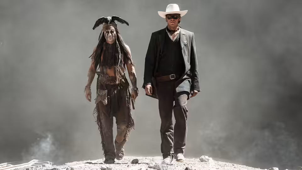 Tonto (Johnny Depp) and the Lone Ranger (Armie Hammer) walking on rocky ground