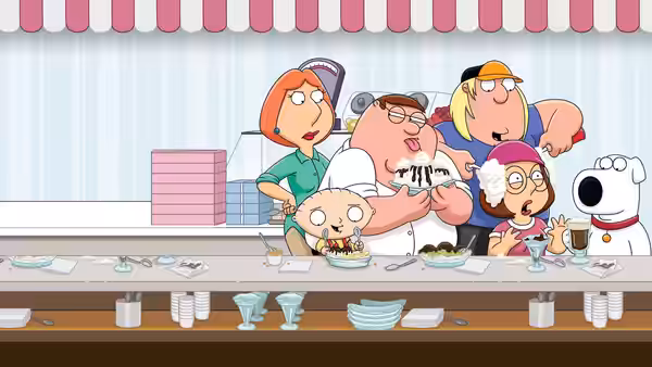 Family sitting at a restaurant counter eating various foods