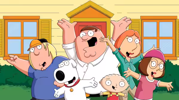 Griffin family posing with arms outstretched in front of their house