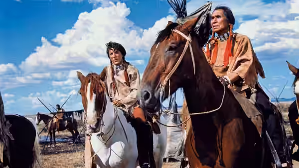 Jack Crabb (Dustin Hoffman) and Old Lodge Skins (Chief Dan George) ride horses through camp