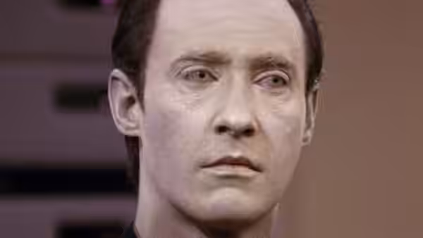 Data (Brent Spiner) looking forward with a neutral expression