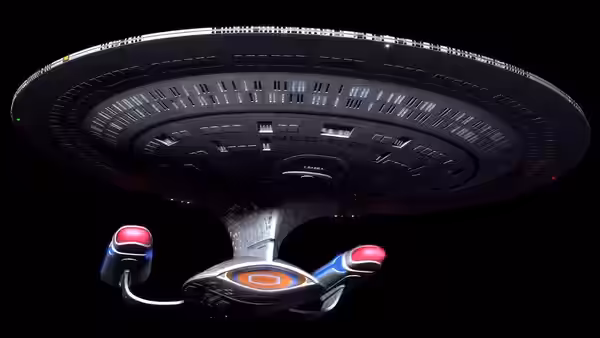 Close underside view of USS Enterprise-D saucer in darkness