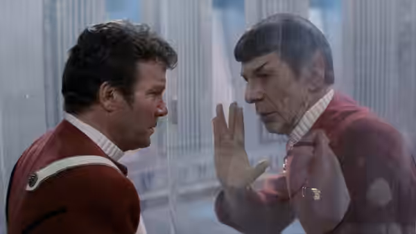 Kirk (William Shatner) facing Spock (Leonard Nimoy) through transparent glass