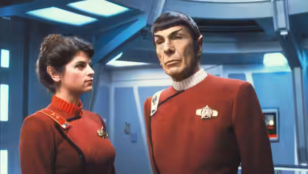 Spock (Leonard Nimoy) standing beside a female officer in uniform