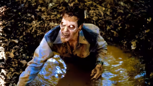 Ash (Bruce Campbell) crawls through muddy water with white eyes